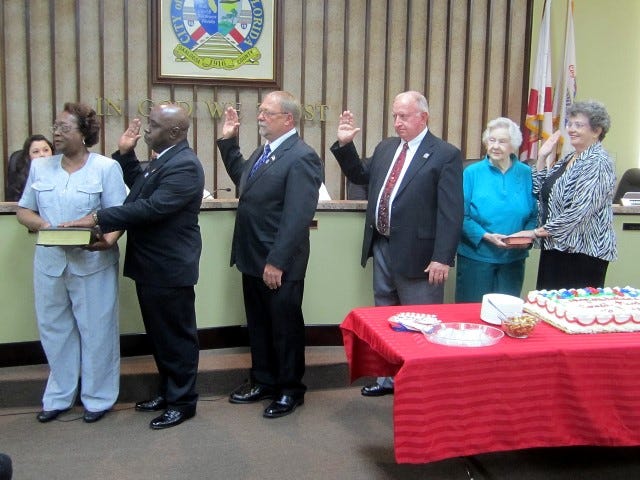 Crestview's new city council members are sworn in before Judge Terry Ketchel. From left are Ann Hayes holding the Bible for her husband, Shannon Hayes; Mickey Rytman; Joe Blocker; and Kathleen Miller holding the Bible for her daughter, City Clerk Betsy Roy.