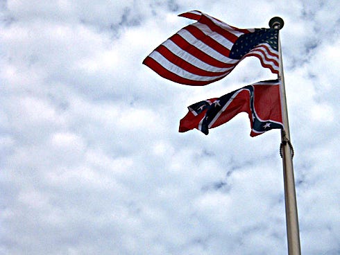 The rebel flag flutters once again beneath Old Glory over Confederate Park following a 2-1 vote of the Crestview City Council to restore the flag.