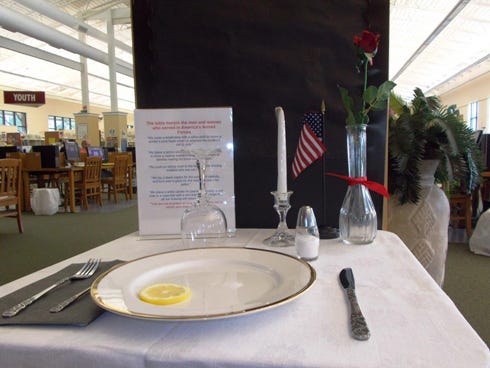 The Table for One is set in memory of missing service members at the Crestview library.
