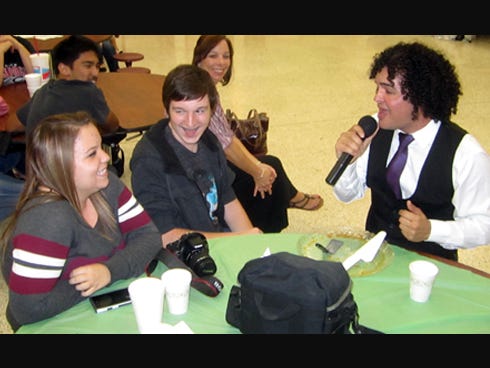"Latin American Idol" singer Amid Montelongo, right, serenades Crestview High junior Hannah Gould at her table as her friend Cole Howell, a sophomore, grins.