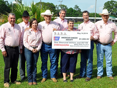 Baker Area Recreation Association members flank Sally Cary, center, of the American Cancer Society on Tuesday during a $1,000 check presentation. From the left are BARA members Joe Fisher, Ben Smith, Edith Elder, Bill Graham, Tim Ross, Mark Todd and Jim Silcox. The funds, collected from the 25th Annual Old Spanish Trail Pro Rodeo, will benefit breast cancer research, Cary said.