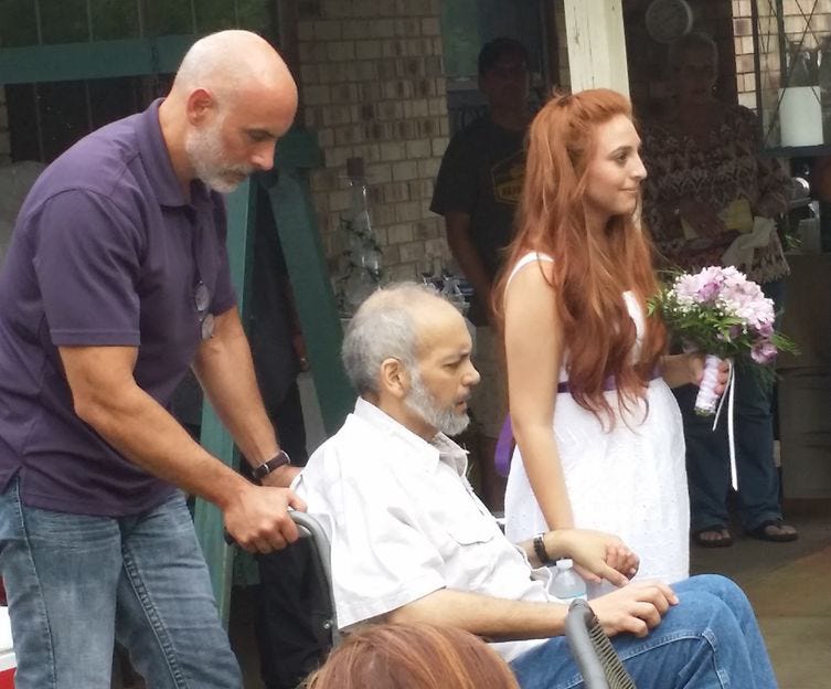 With his brother, Robert's, assistance, Roger Berry, center, escorts his daughter, Alycia, down the aisle during a July 12 backyard ceremony. Berry died from liver cancer on July 27.