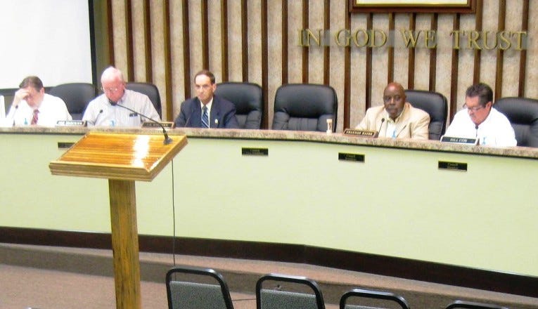 The Crestview City Council seat formerly occupied by Mickey Rytman lies vacant during a recent council meeting. Ten residents, including three former council members, have applied to fill the rest of Rytman's term.