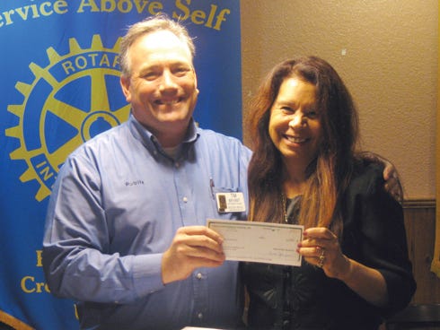 Crestview Publix grocery store manager Tim Bryant presents a $60,000 Publix Supermarkets Charities check to Habitat for Humanity of Okaloosa County President and CEO Nitsi Bennett.