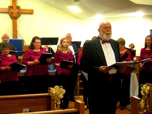 Director John Leatherwood introduces the Northwest Florida State College-based Schola Cantorum community choir to its Crestview audience during Wednesday’s concert.