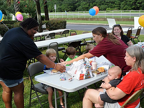 Dailah Catherine Wade, 13, serves drinks for customers during "McDrew Night." The Crestview fast food restaurant's owners are donating 20 percent of Monday's 4-to-8-p.m. sales to Drew Barefield's family.