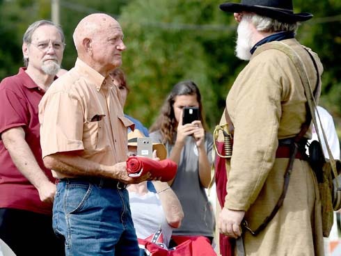 Civil War re-enactor Eli Chandler — of the Company E 1st regiment of Florida Volunteer Infantry, right — salutes Delano Lundy on Nov. 7. Chandler gave him the Confederate flag that was removed from public property where the William “Bill” Lundy Memorial once stood in Crestview. Sheila Hall, a Crestview resident of 69 years, says the flag never should have been removed.