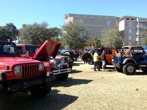 Jeep owners and fans admire a selection of Jeeps on display at last year's All American Jeep Show in Fort Walton Beach. Organizers hope to attract more than three times as many Jeeps to this year's regional show, to be held in Crestview.