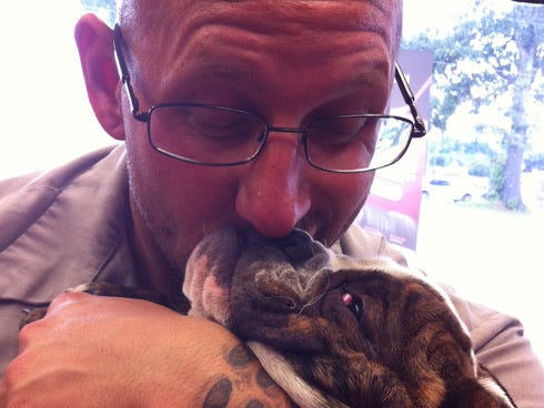 Mark Kempski, owner of Kempski Tires, is pictured with his dog, Mocha. Kempski died at age 36 on June 17.