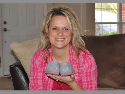 Yvonne Wood, of Crestview, holds her pair of TOMS shoes. The company’s corporate responsibility program, which involves donating a pair of canvas shoes for each pair purchased, informed her of an upcoming trip abroad to place footwear on needy children’s feet. She’s seeking votes for the mission trip.