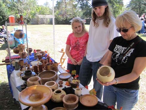 Attendees eye a vendor's woodwork at the 2011 October Arts Festival at Laurel Hill Presbyterian Church. The church has scheduled an April 13 community art fair at 8115 4th St.