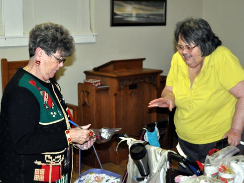 Bev Lilley, left, of the women's ministry at First Baptist Church of Crestview, assists Helen Malone, a resident at Crestview Manor, in selecting gifts for friends and family at the Christmas store on Monday night. For one night only, residents were able to pick items free of charge and have them wrapped in Christmas paper.