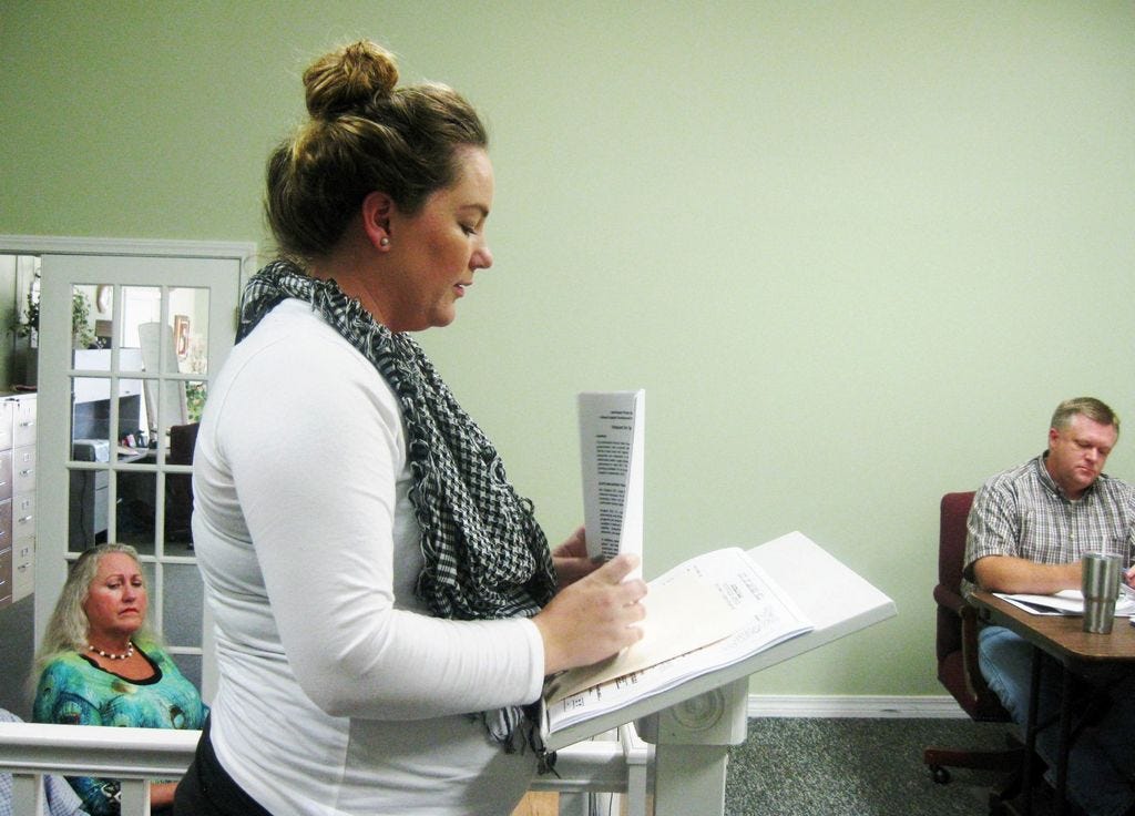 Crystal Wetherington of Preble-Rish Consulting Engineers presents information to the Laurel Hill City Council about new Northwest Florida Water Management District grants becoming available. Municipal consultant Pat Blackshear, left, and Mayor Robby Adams listen.