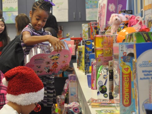 Kimberly Edmunds, center, Carson Berage, bottom, and fellow classmates organize toy donations for "Giving Instead of Receiving.” Jennifer Richard's fourth-graders at Riverside Elementary School participated in the effort.