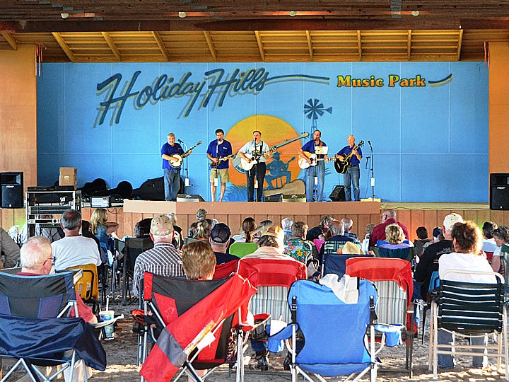 Bluegrass enthusiasts settle under the pole barn at Holiday Hills Music Park in Laurel Hill for a weekend of music.