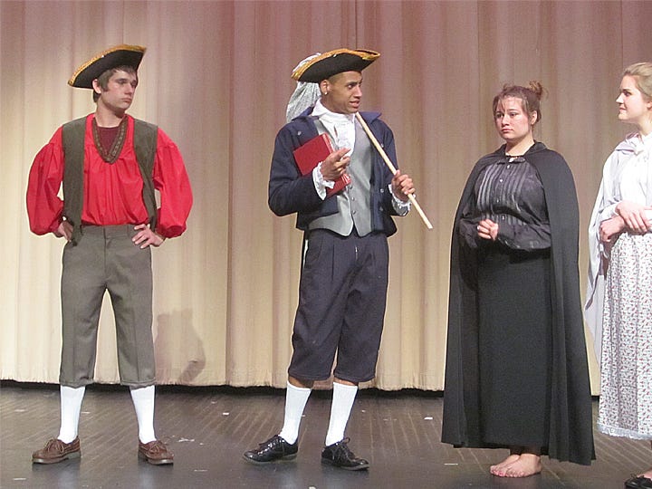 Bully Brom Bones (Wesley Barlow, left) is unimpressed by Sleepy Hollow's new schoolmaster Ichabod Crane (Carmine Harrell), who chats with the Widow Van Doorn and Mrs, Van Tassel (Katie Rocha and Courtney Jones).