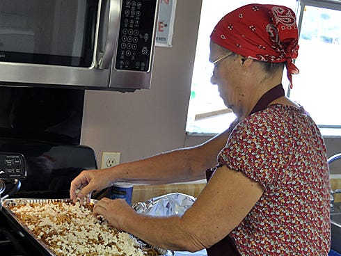 Linda Jordan, of Helping Hands Ministry, prepares baked spaghetti at Shady Grove Assembly of God in Baker.