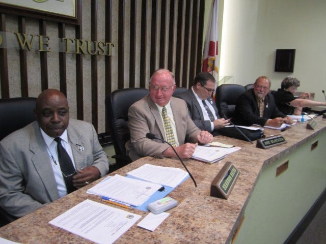 From left, new Crestview City Councilman Shannon Hayes grins after getting his chair height adjusted as he joins fellow freshmen Joe Blocker and Mickey Rytman, far right, and Councilman Tom Gordon on the dais.