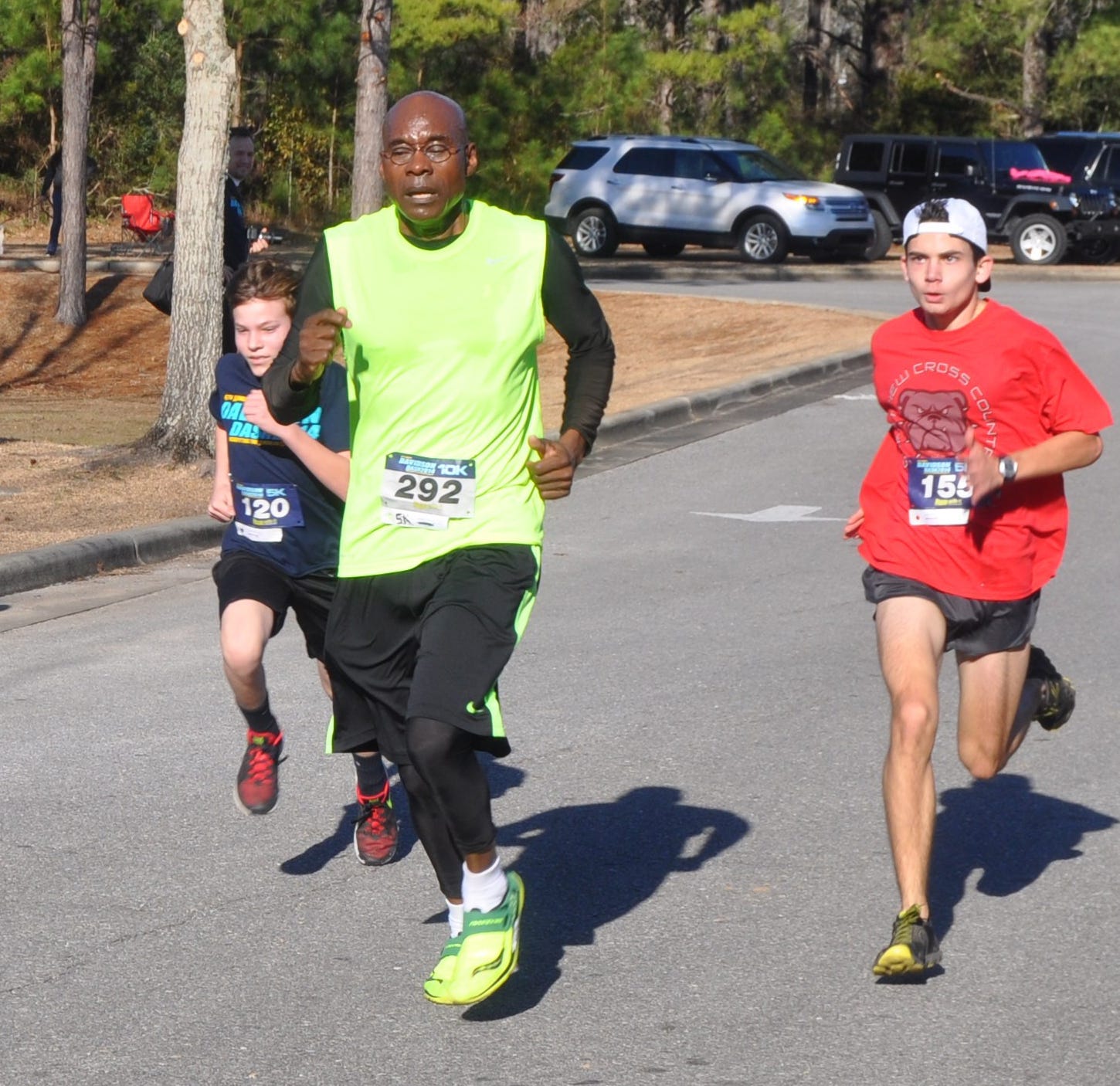 From the left, 12-year-old Trey Kolmetz, Anthony Johnson and Jacob Cyrus, 14, run down the final stretch of the Davidson Dash 5K/10K event at Davidson Middle School on Saturday. This year's Dash raised more than $7,000 for the American Cancer Society.