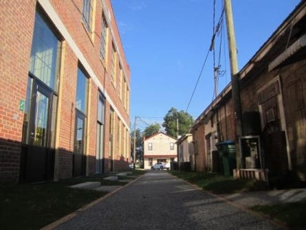The ownership of the alleyway between the Alatex building, left, and several rear entrances to businesses on Main Street in Crestview, remains unsettled. On Monday night, the city council voted not reach a settlement agreement with the family of Purl G. Adams, who dispute the city's ownership of the alleyway.
