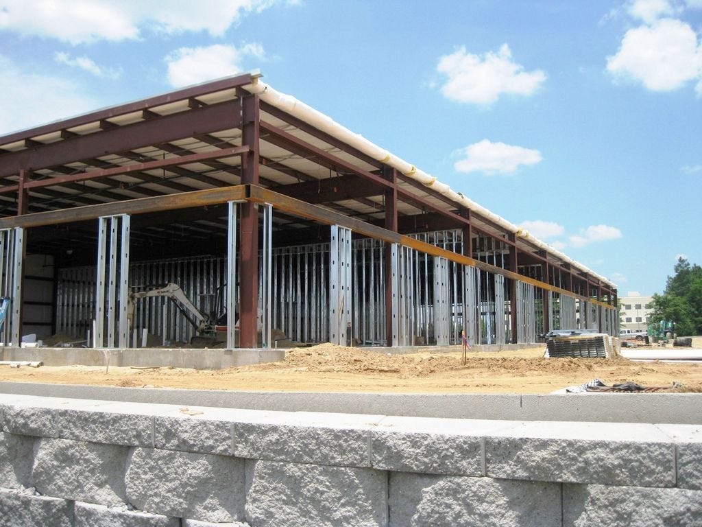 A shopping center — which currently includes Panera Bread and Papa Murphy's Pizza — rises on State Road 85 in the spring of 2014. Such a commercial facility requires multiple city permits, both from the builders and from the tenants. The city is currently evaluating its fee schedule, which requires a June 13 vote to go into effect.