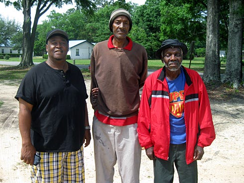 Al Flowers, a Crestview deacon and advocate for North Okaloosa County's needy residents, left, has helped Doug Frederick, middle, file paperwork for Social Security benefits and has provided Charles Williams a monthly haircut. It's all part of his outreach efforts that began more than six years ago.