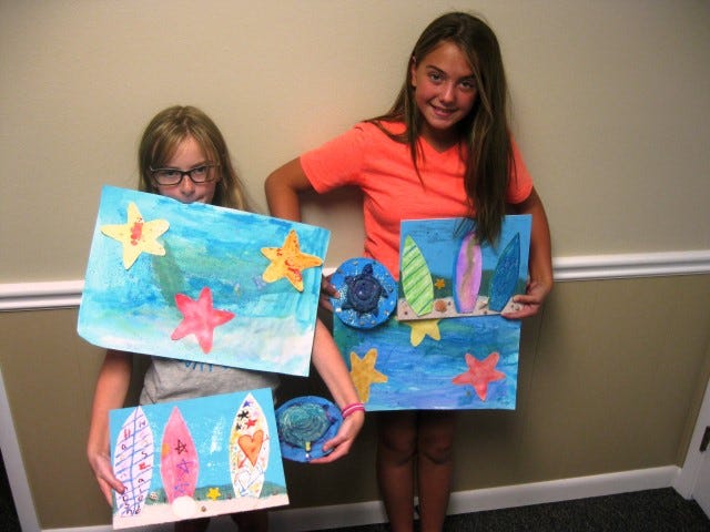 Baker School students Hadyn Hensz and Madison Stanley, both 10, display three projects they made this week during the Abrakadoodle Summer Art Camp.