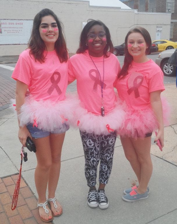 Northwest Florida State College students Shiloh Raymond, Jasmine Knox and Brittany Fahn are among Crestview area residents showing their support for Breast Cancer Awareness Month. Attending North Okaloosa Medical Center's Oct. 1 Pink Street Party on Main Street was one way to stand up for friends and loved ones diagnosed with cancer, they said.
