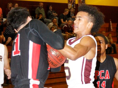 Baker School's Derek Peoples (right) — battles a Pensacola Christian Academy player for the ball earlier this season — "travels a lot and plays a lot of teams (from around the country), so I think he's a lot more mature than his age," Gator Coach Janavor Weatherspoon says.