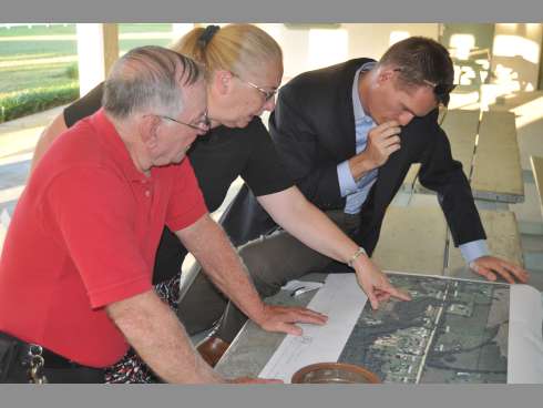 Bob and Donna Smith and County Commissioner Nathan Boyles eye a map of McCauley road following a Thursday community meeting at the Baker Recreation Center. Boyles plans to draft a proposal in the next couple of weeks to tax the road’s residents for the dirt road’s maintenance and improvements.