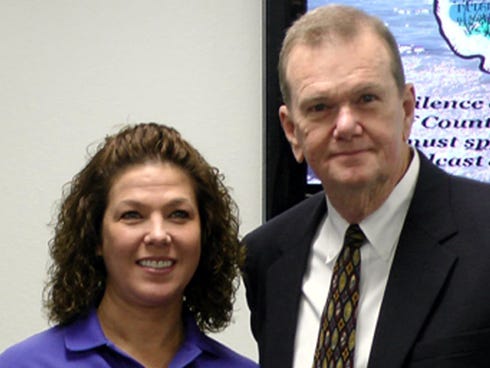 Emergency Medical Technician Barbara Chestnut, pictured with County Administrator Ernie Padgett, is a HERO Award recipient after feeding a child's weak great-grandmother last fall.