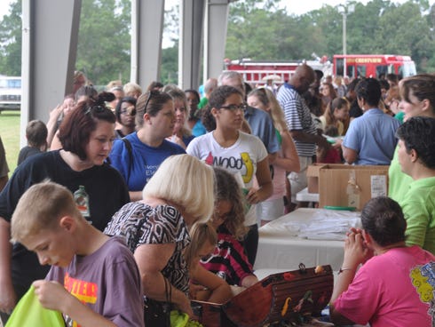 Parents and children receive school supplies at last year’s Back-To-School Bash sponsored by Calvary United Church and Hub City Ford. Event organizers are now collecting school supplies for needy local students.