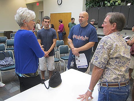 Kyle Davis and his father, J.P., center, learn more about the Crestview Sister City program from members Pam, left, and Joe Coffield.