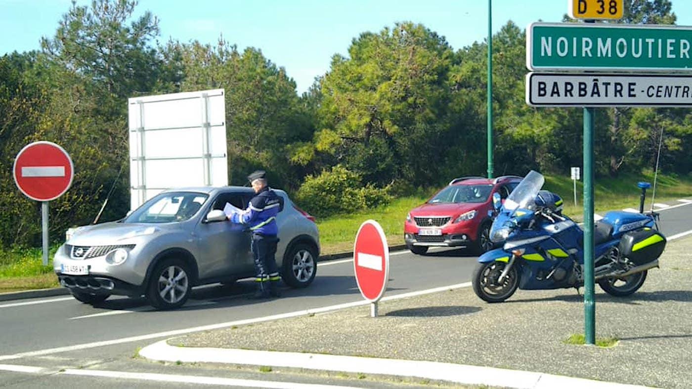 An officer from the Vendée Gendarmerie’s Noirmoutier barracks checks a motorist’s travel documents before allowing the vehicle onto the island on March 16.