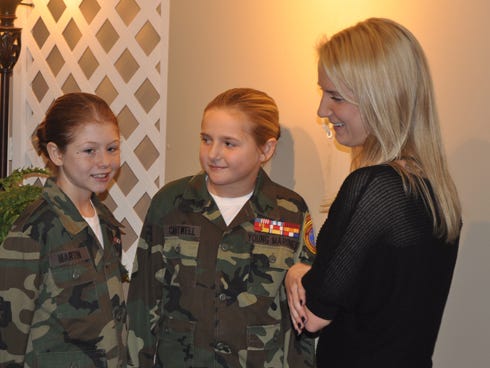 Pvt. Makayla Martin, 11, left, and Pfc. Michaela Cantwell, 10, center, of Milton speak with Sgt. Kirstie Ennis, of Milton, Saturday at an Elks Lodge luncheon in Crestview. The Emerald Coast Young Marines honored Ennis, who received serious injuries in a helicopter crash while serving in Afghanistan.