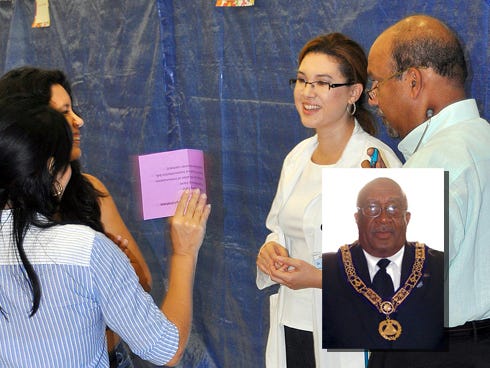 Doctors Anacani Fonseca and Joseph Peter speak with a family during the 2013 No Child without Health Care Fair. The annual event returns Saturday to Crestview High School. INSET: Malcolm Haynes, 3rd Masonic District Deputy Grand Master. (Special to the News Bulletin)