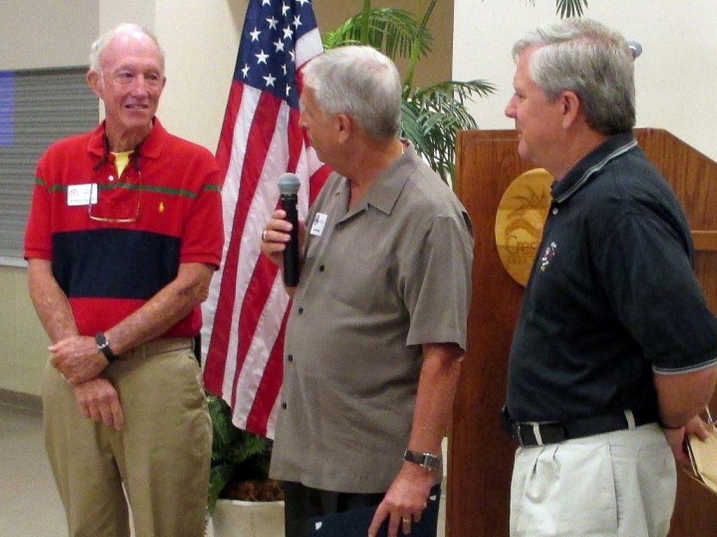 Economic Development Council Defense Support Initiative representatives Kim Wintner and Jim Heald recognize Maj. Tom Moody, U.S. Army (retired), left, for seven years of volunteer service to the initiative.