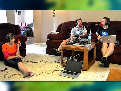 Mary Gadeken — left, with Dermot Whelan and Dave Moore broadcasting "Laughternoons with Dermot and Dave" last week from her Baker living room — plans to visit the Irishmen on May 30.