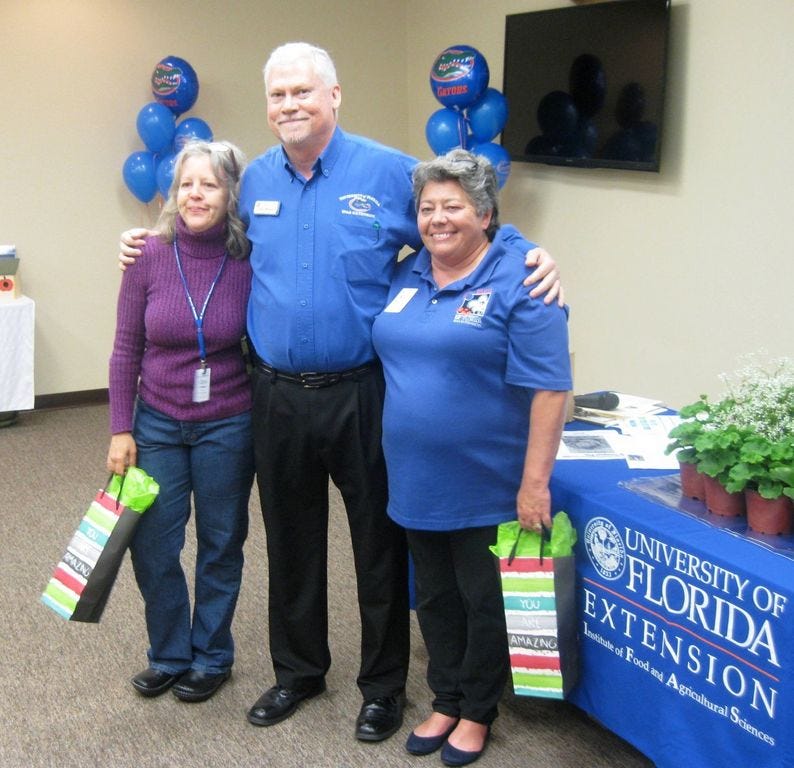University of Florida Okaloosa County Extension Director Larry Williams recognizes Master Gardeners Stacy Taylor and Marge Stewart for their dedicated service during a Feb. 24 awards luncheon.
