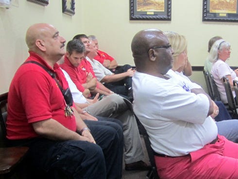 Crestview Fire Department members, including Battalion Chief Dave Brown, left foreground, and residents such the Rev. Sanford Hayes, center foreground, were among those attending the Crestview City Council’s final budget hearing.