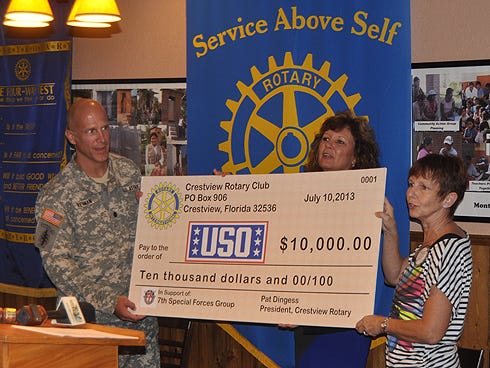 Lt. Col. Chad Reiman of the 7th Special Forces Group (Airborne) accepts a $10,000 check from the Crestview Rotary Club. Presenting the check are USO of Northwest Florida director Heidi Blair and former Rotary president Pat Dingess.