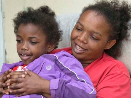 Jamichia Ewing wears a magnetic wristband that can activate an implant near her shoulder that sends electrical signals to her brain, hopefully stopping her epileptic seizures.