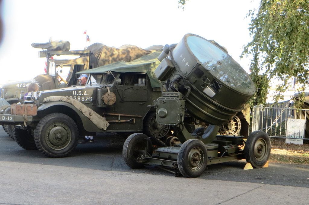 Members of the Noirmoutier, France-based Atlantic Wall Memory World War II historic preservation and re-enactment association seek help from members of their Crestview Sister City in restoring this 1940s American anti-aircraft searchlight.