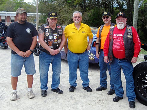 Crestview American Legion Post 75 Commander Jeff Williams, Legacy Ride road captain Bobby Patrick, American Legion Department of Florida Commander Jay Conti, Riders Chapter 75 director Bob Schirg, and Rider Mike Kirchoff stand among Legacy Ride bikes and escort vehicles.