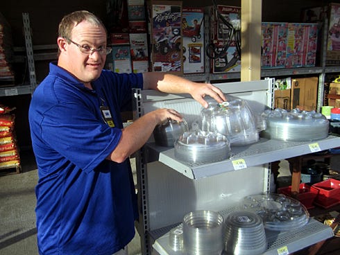 Danny Parker adjusts merchandise in the garden center of the Crestview Wal-Mart, where he's worked for 20 years.