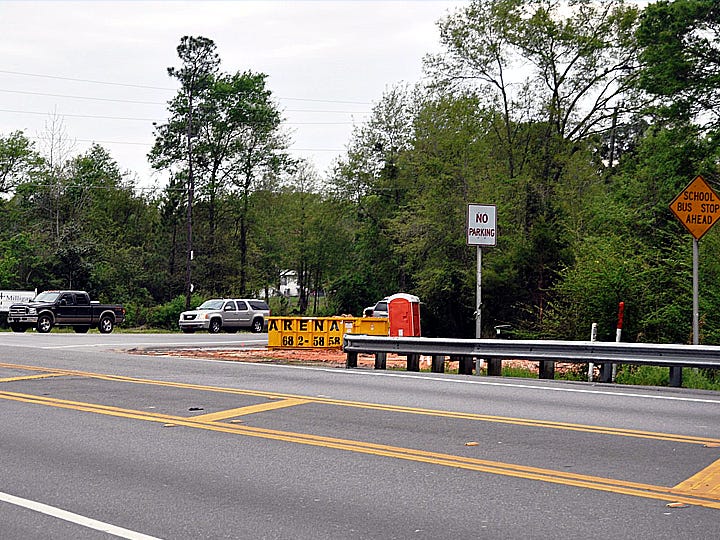 A refuse container and a portable toilet mark the spot where a dilapidated former grocery store was demolished. Part of the lot will be turned into a right turn lane from U.S. Highway 90, foreground, onto State Road 4 leading to Baker.