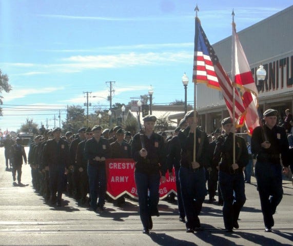 Crestview High School's Army ROTC battalion marches down Main Street near the beginning of the city's Veterans Day parade.