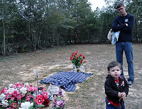 Noah Danio, 1, and his father, Dakota, visit the gravesite of Noah's mother, Alana Peaden. The family says recent thefts from Alana's gravesite will not deter them from keeping her memory alive.