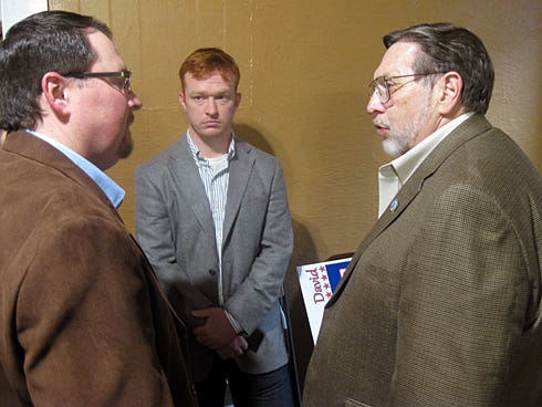 Mayoral candidate Jeremiah Hubbard congratulates Mayor David Cadle following Cadle’s re-election Tuesday night.