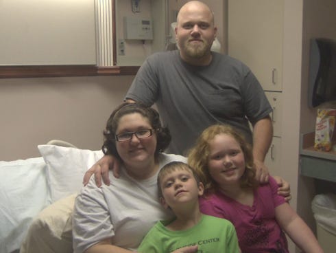 The Brooks family from Crestview is expecting mono-mono twins who share the same amniotic sac and placenta. From the left are Lyndsey and Brandon and their children, Logan and Amelia.